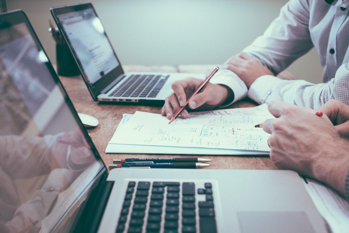 Person planning strategy at desk — the difference between using AI and having an AI strategy
