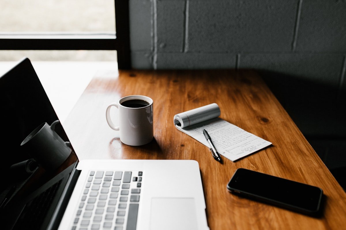 Laptop on a clean desk — the blank page problem with AI prompting